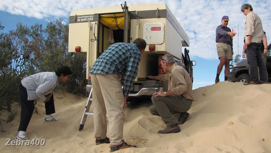 23-Shane & Wayne check out the damage to the camper pack.JPG